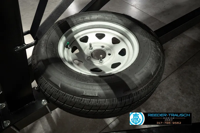 Slide: The Image of Trailer tire on display at Reeder-Trausch Marine, related to Bennington L 25 Quad Bench Bowrider. - 60