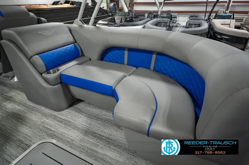 Slide: The Image of 2025 Bennington L 25 Quad Bench Bowrider with luxurious gray and blue seating. - 47