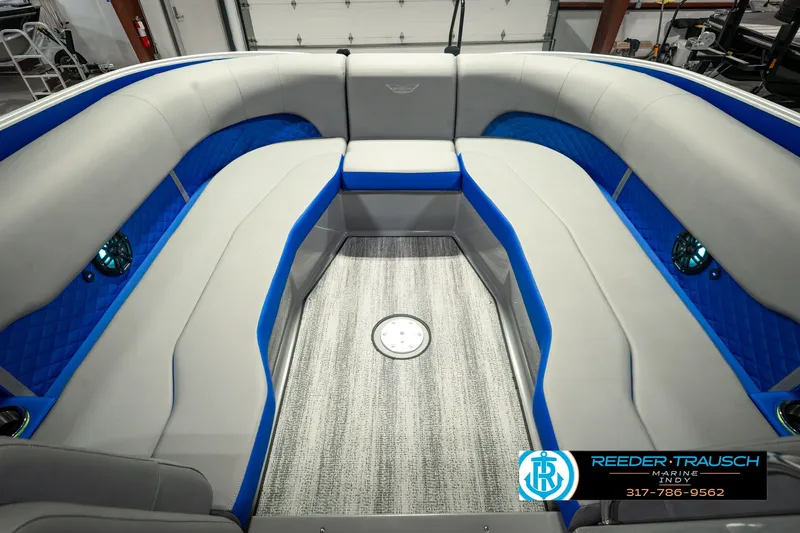 Slide: The Image of 2025 Bennington L 25 Quad Bench Bowrider interior with gray and blue seating. - 25