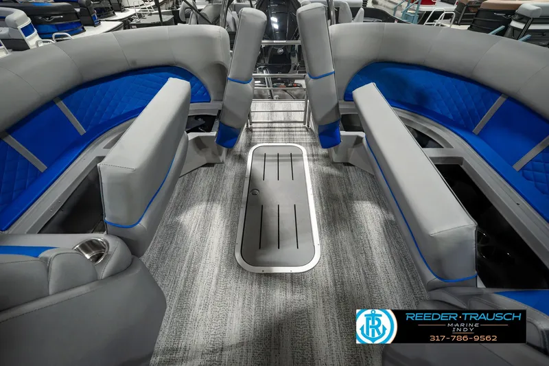 Slide: The Image of 2025 Bennington L 25 Quad Bench Bowrider interior with gray and blue seating. - 34