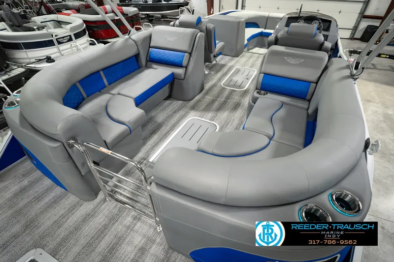 Slide: The Image of 2025 Bennington L 25 Quad Bench Bowrider with luxurious gray and blue seating. - 16