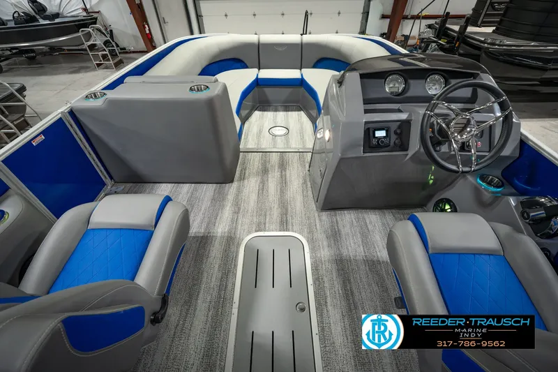 Slide: The Image of 2025 Bennington L 25 Quad Bench Bowrider interior with modern seating and sleek dashboard design. - 24