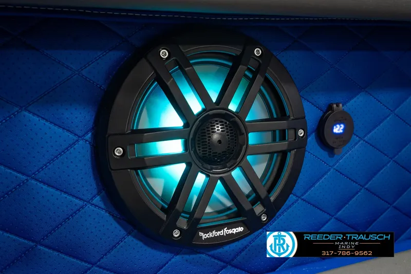 Slide: The Image of Illuminated Rockford Fosgate speaker on blue quilted interior of 2025 Bennington L 25 Quad Bench Bowrider. - 48