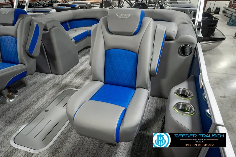 Slide: The Image of 2025 Bennington L 25 Quad Bench Bowrider interior with blue and gray seating. - 46