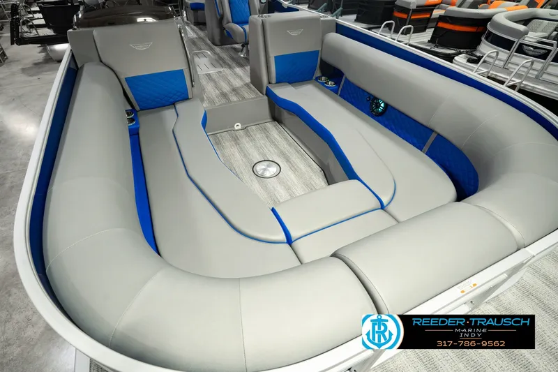 Slide: The Image of 2025 Bennington L 25 Quad Bench Bowrider interior with gray and blue seating. - 14