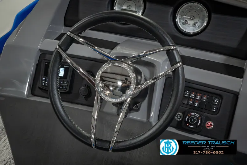 Slide: The Image of Steering wheel of 2025 Bennington L 25 Quad Bench Bowrider with control panel. - 35
