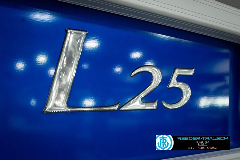 Slide: The Image of Close-up of 2025 Bennington L 25 Quad Bench Bowrider emblem on blue background. - 57