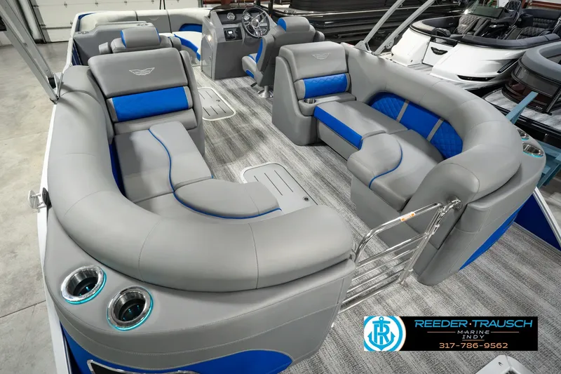 Slide: The Image of 2025 Bennington L 25 Quad Bench Bowrider with luxurious gray and blue seating. - 17