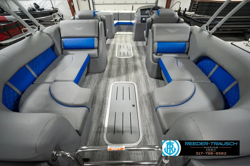 Slide: The Image of 2025 Bennington L 25 Quad Bench Bowrider interior with gray and blue seating, spacious layout. - 22