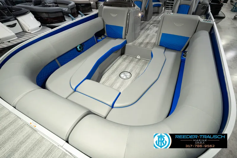 Slide: The Image of 2025 Bennington L 25 Quad Bench Bowrider with luxurious gray and blue seating. - 13
