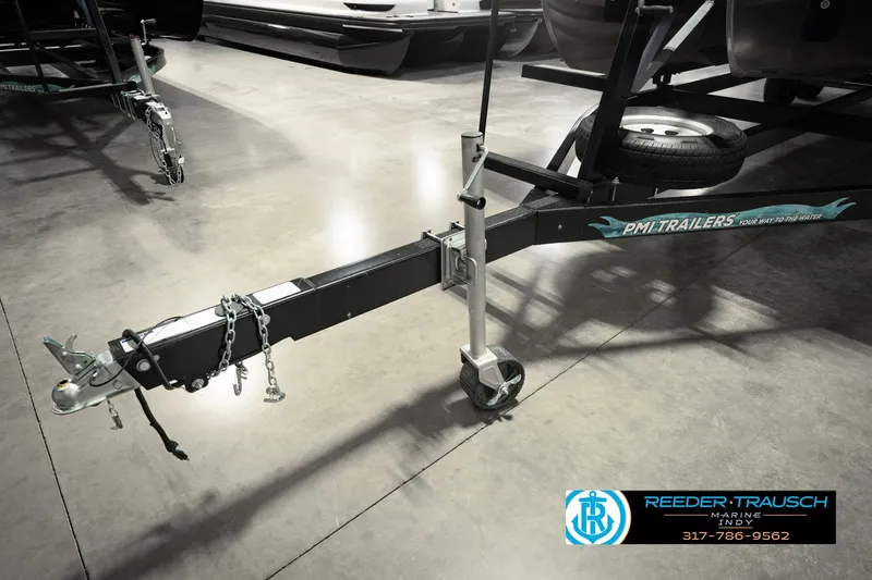Slide: The Image of Trailer hitch for Bennington L 25 Quad Bench Bowrider, 2025 model, in showroom setting. - 58