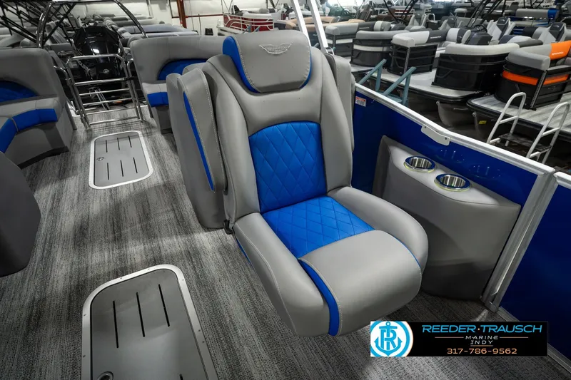 Slide: The Image of 2025 Bennington L 25 Quad Bench Bowrider interior with blue and gray seating. - 30