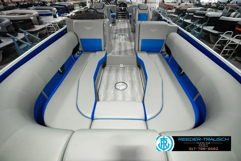Slide: The Image of 2025 Bennington L 25 Quad Bench Bowrider interior with gray and blue seating. - 18