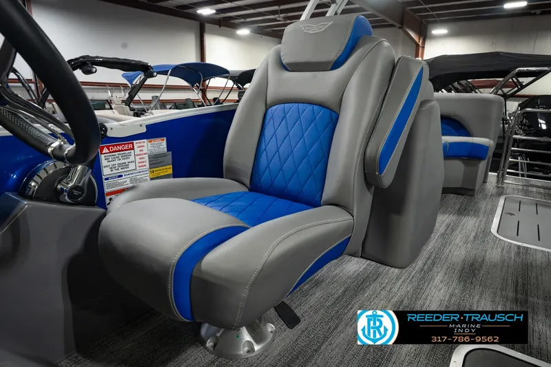 Slide: The Image of 2025 Bennington L 25 Quad Bench Bowrider interior with blue and gray seating. - 43