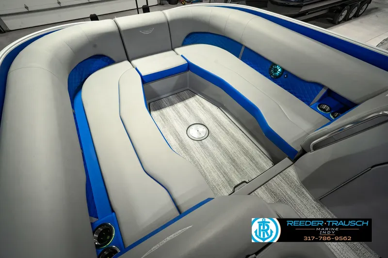 Slide: The Image of 2025 Bennington L 25 Quad Bench Bowrider interior with gray and blue seating. - 45
