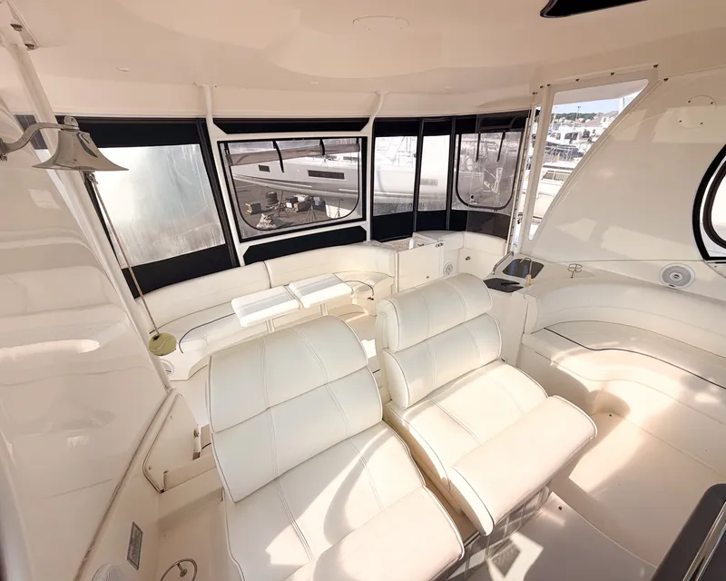 Slide: The Image of The interior of a 2007 Cruisers Yachts 455 Motor Yacht with white leather seating and large windows. - 7