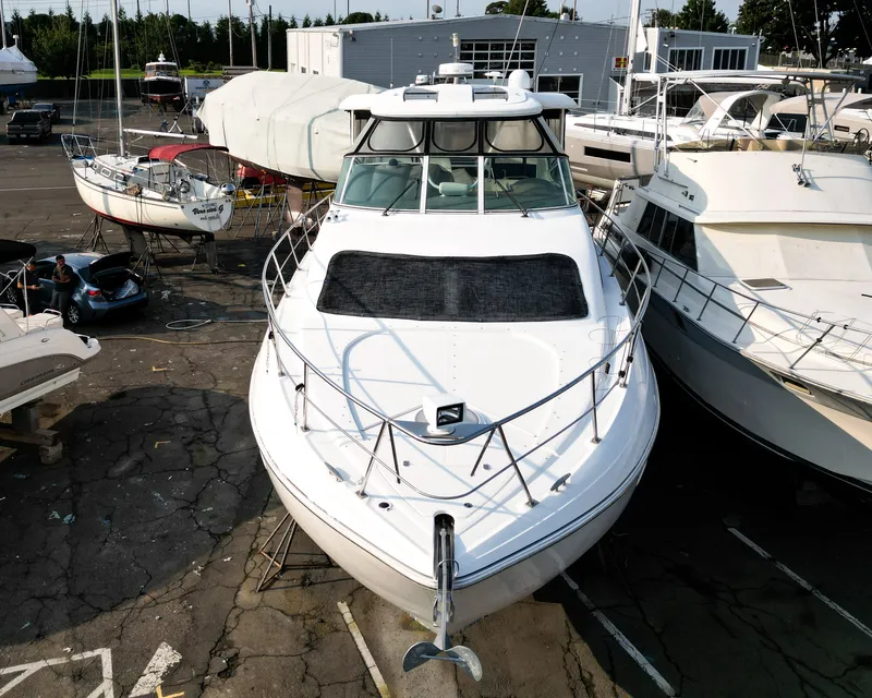 Slide: The Image of A 2007 Cruisers Yachts 455 Motor Yacht is parked, surrounded by other boats. - 1