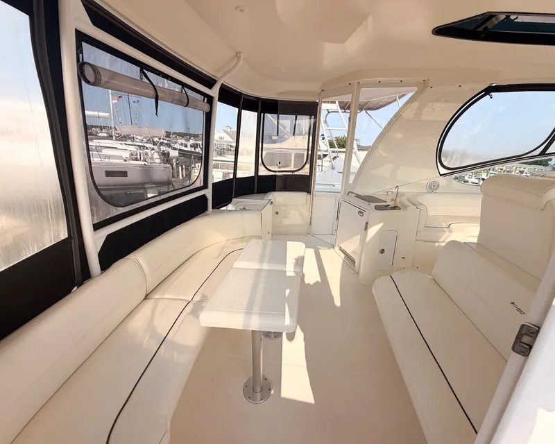 Slide: The Image of The 2007 Cruisers Yachts 455 Motor Yacht features a spacious, elegant salon with white leather seating. - 8