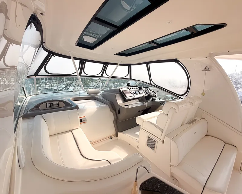 Slide: The Image of Interior of a luxury yacht with white leather seating and a modern helm station. - 5