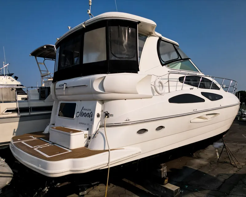 Slide: The Image of A luxurious white motor yacht with a spacious deck and sleek windows, docked at a marina. - 3
