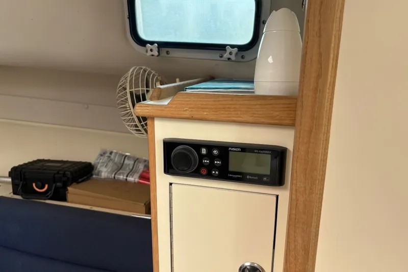 Slide: The Image of Interior of 1998 Albin 28 Tournament Express with radio and storage cabinet. - 5
