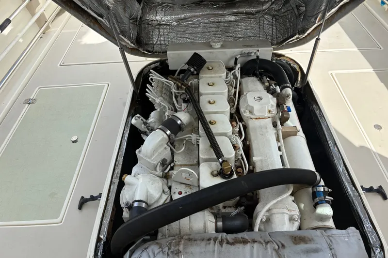 Slide: The Image of Engine compartment of a 1998 Albin 28 Tournament Express boat, showcasing detailed mechanical components. - 8