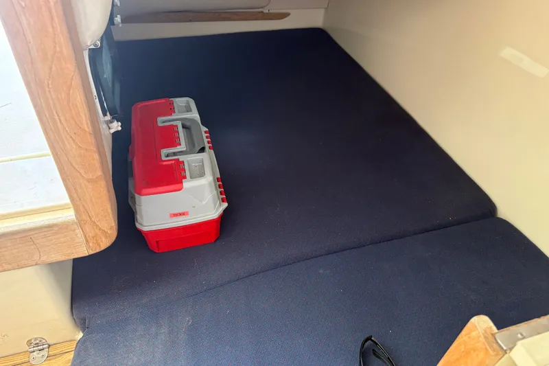 Slide: The Image of Interior of 1998 Albin 28 Tournament Express with red tackle box on blue carpet. - 3