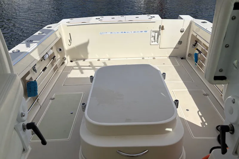 Slide: The Image of 1998 Albin 28 Tournament Express boat deck with storage compartments and fishing rod holders. - 12