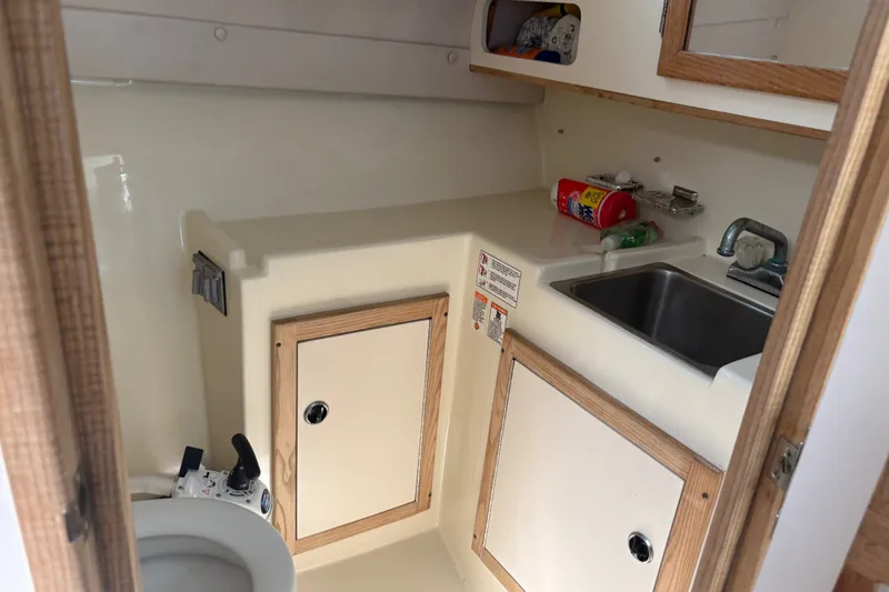 Slide: The Image of 1998 Albin 28 Tournament Express boat interior with sink and storage cabinets. - 2