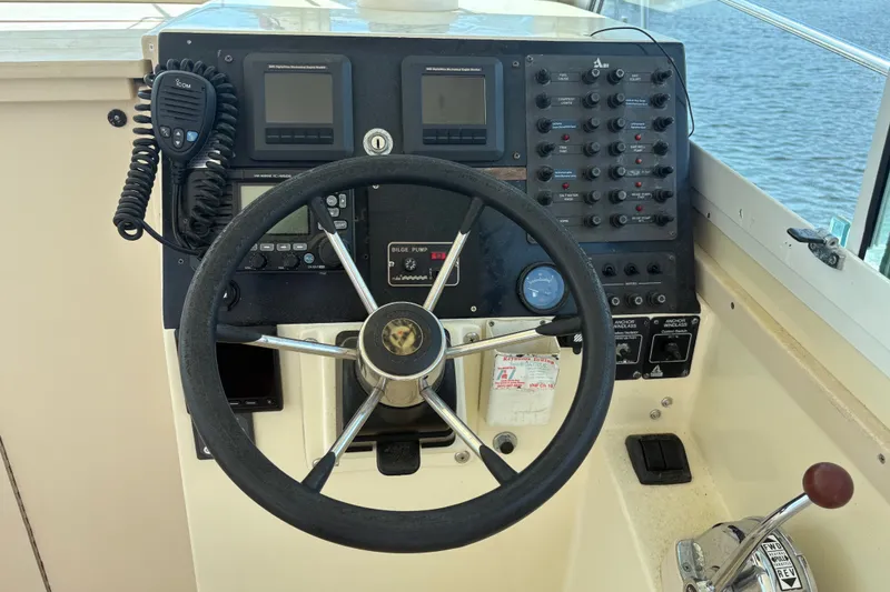 Slide: The Image of Helm of 1998 Albin 28 Tournament Express with steering wheel and control panel. - 13