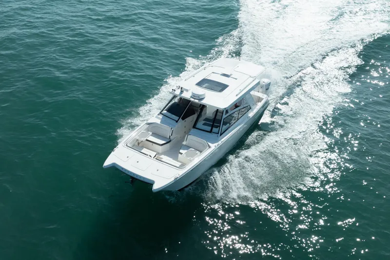 Slide: The Image of 2024 World Cat 400 DC-X cruising on open water, aerial view. - 10