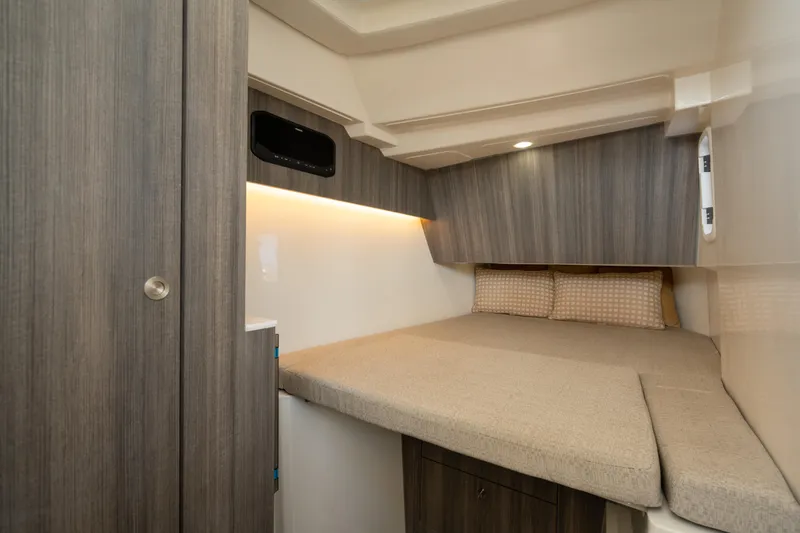 Slide: The Image of 2024 World Cat 400 DC-X cabin interior with cozy bed and modern wood paneling. - 23