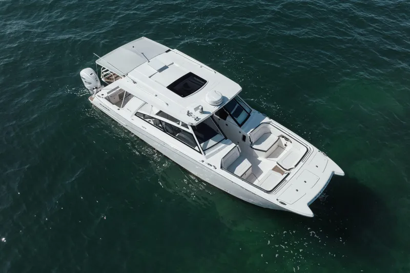 Slide: The Image of 2024 World Cat 400 DC-X boat cruising on open water, aerial view. - 3