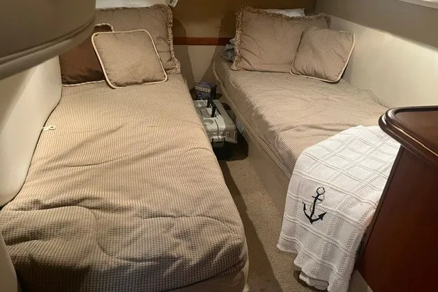 Slide: The Image of Interior cabin of 2001 Cruisers Yachts 4270 Express with twin beds and nautical decor. - 20