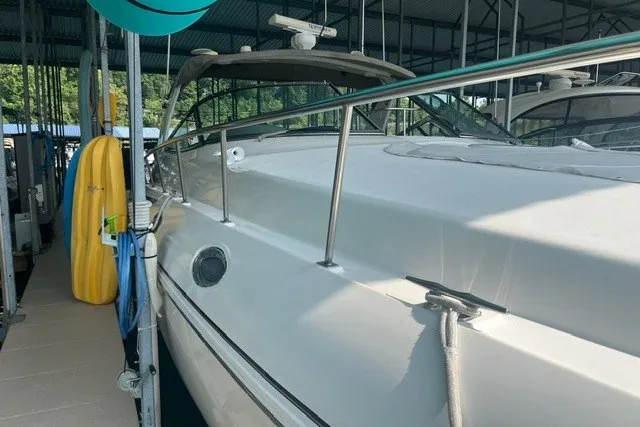Slide: The Image of 2001 Cruisers Yachts 4270 Express docked in a covered marina. - 32