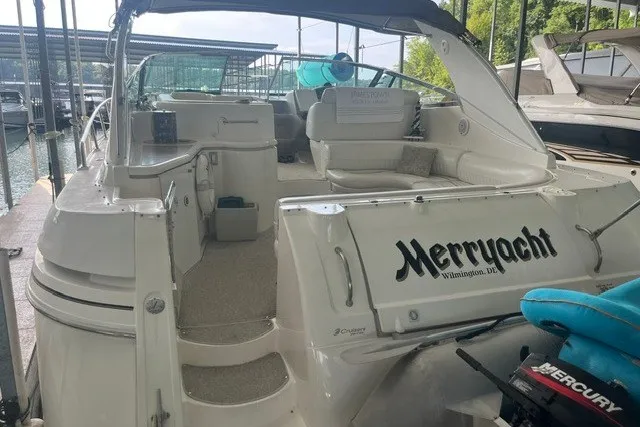 Slide: The Image of 2001 Cruisers Yachts 4270 Express docked, featuring spacious seating and "Merryacht" branding. - 34