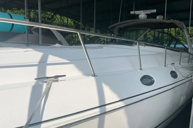 Slide: The Image of 2001 Cruisers Yachts 4270 Express, white exterior, docked under a covered marina. - 31