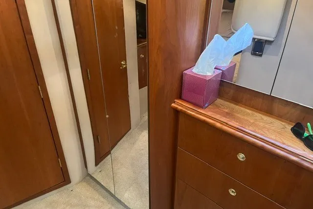Slide: The Image of Interior of 2001 Cruisers Yachts 4270 Express with wood cabinetry and mirrored door. - 17