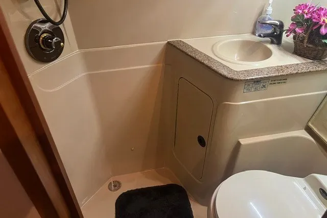 Slide: The Image of Bathroom interior of 2001 Cruisers Yachts 4270 Express with sink and toilet. - 19