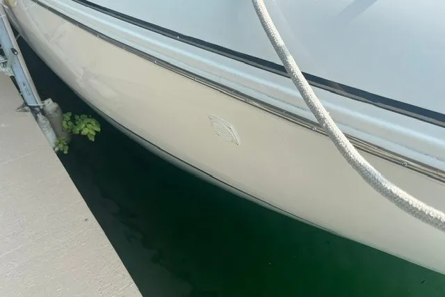 Slide: The Image of 2001 Cruisers Yachts 4270 Express docked, showing sleek white hull and mooring rope. - 33