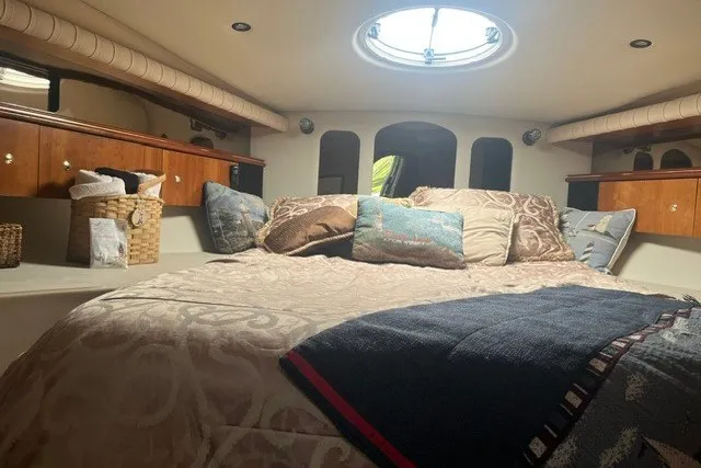 Slide: The Image of Luxurious cabin interior of 2001 Cruisers Yachts 4270 Express with cozy bedding and elegant decor. - 27