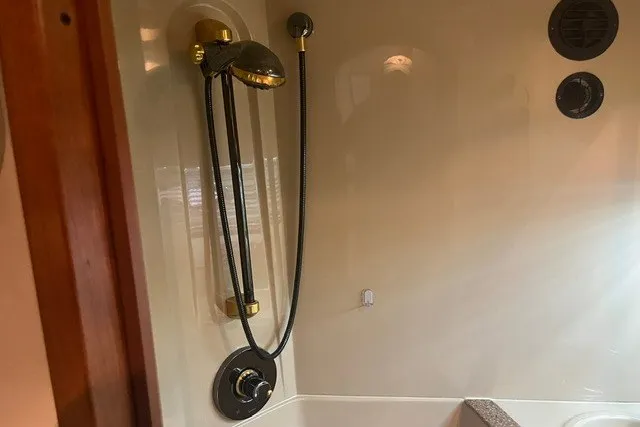 Slide: The Image of Shower area in 2001 Cruisers Yachts 4270 Express with gold fixtures and modern design. - 18