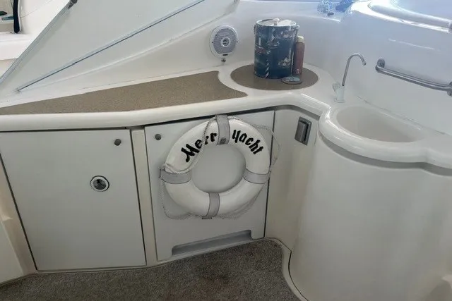 Slide: The Image of 2001 Cruisers Yachts 4270 Express interior with sink, countertop, and life preserver. - 24