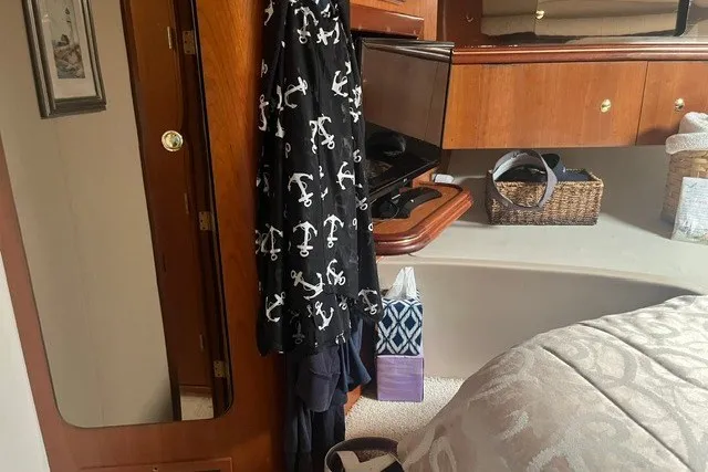 Slide: The Image of Interior of 2001 Cruisers Yachts 4270 Express with wooden cabinetry and nautical-themed decor. - 25