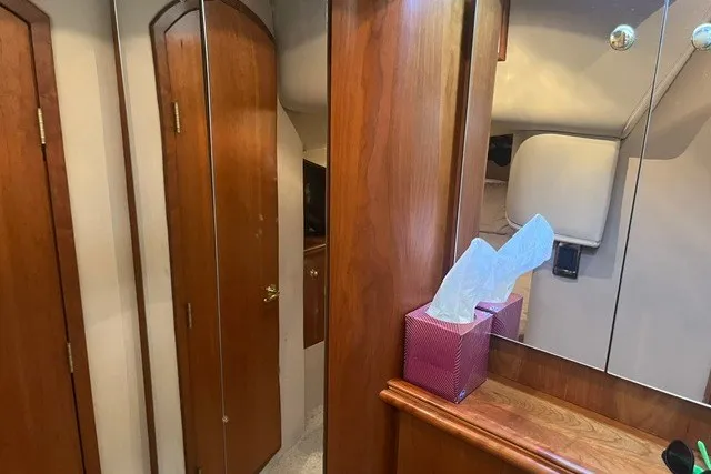 Slide: The Image of Interior of 2001 Cruisers Yachts 4270 Express with wooden cabinetry and mirrored surfaces. - 30