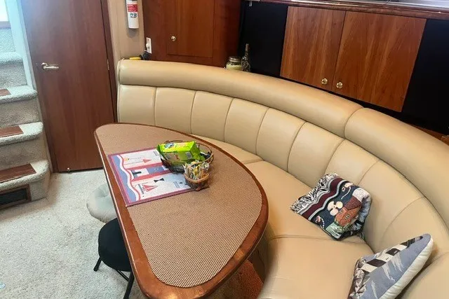 Slide: The Image of Luxurious interior of 2001 Cruisers Yachts 4270 Express with curved seating and wooden accents. - 22