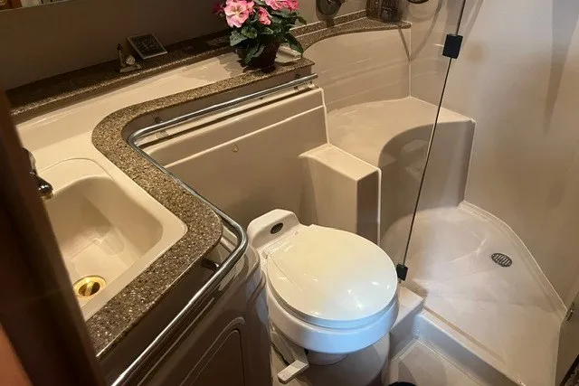 Slide: The Image of Luxurious bathroom in 2001 Cruisers Yachts 4270 Express with modern fixtures and elegant design. - 29