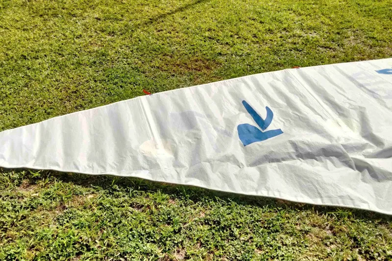 Slide: The Image of White sail with blue logo on grass, Rebel Mark IV, 2001 model. - 18
