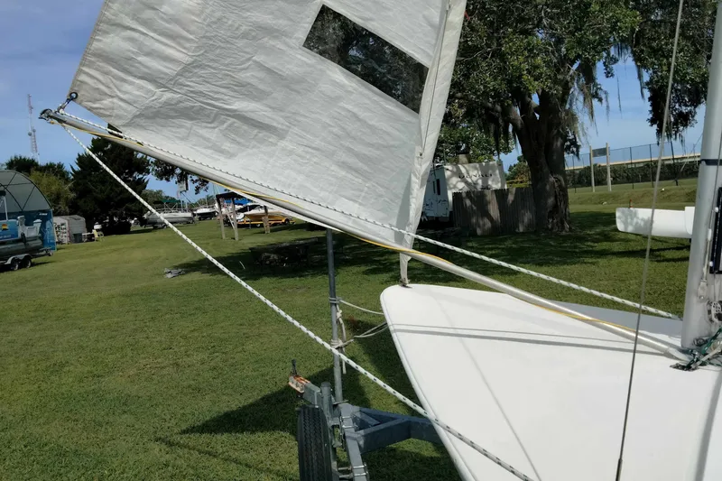 Slide: The Image of Sailboat on trailer in grassy area, featuring Rebel Mark IV, 2001 model. - 16