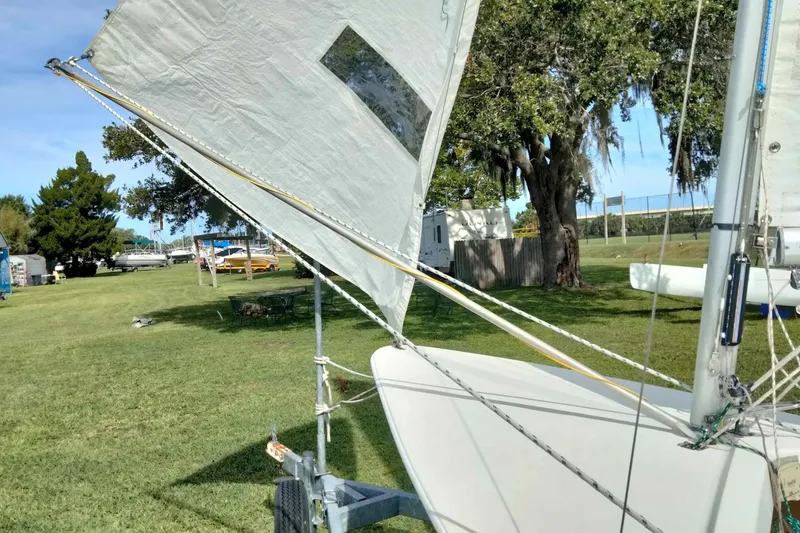 Slide: The Image of Sailboat on grassy area with trees, featuring Rebel Mark IV, 2001 model. - 15